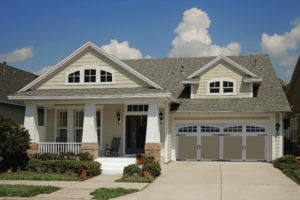 A beautiful home with a decorative garage door.