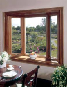 A beautiful, wood-framed bay window in a kitchen.