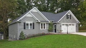 A single-family home with gray siding and roofing.