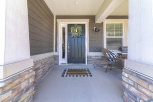 Home exterior with gray siding and black front door