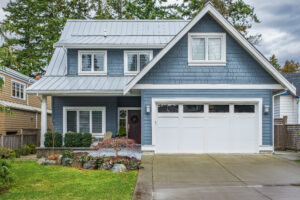 Suburban home with blue siding and white-framed windows